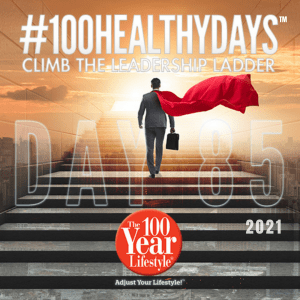 A man in a suit with a red cape climbs stairs toward sunlight. Large text reads “#100HEALTHYDAYS™ DAY 85.” Additional text says “CLIMB THE LEADERSHIP LADDER,” “2021,” and “The 100 Healthy Days Lifestyle.”.