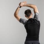 Image from back of athletic man doing exercise while working out