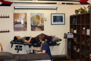 spinal traction table with patient and chirporactor